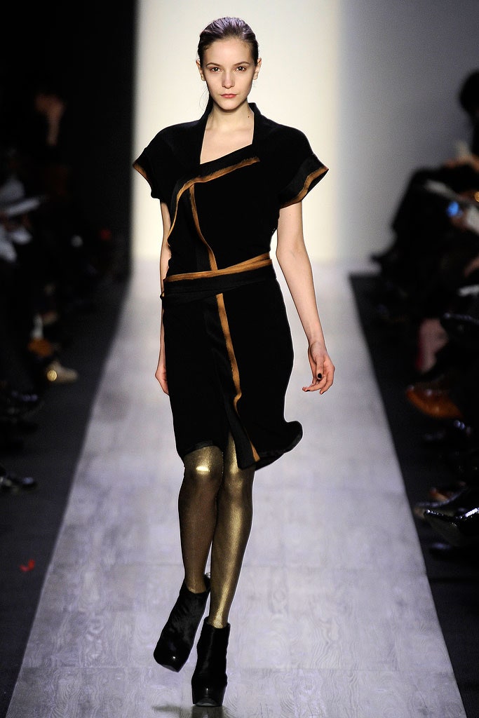 black velvet asymmetric dress with gold leggings