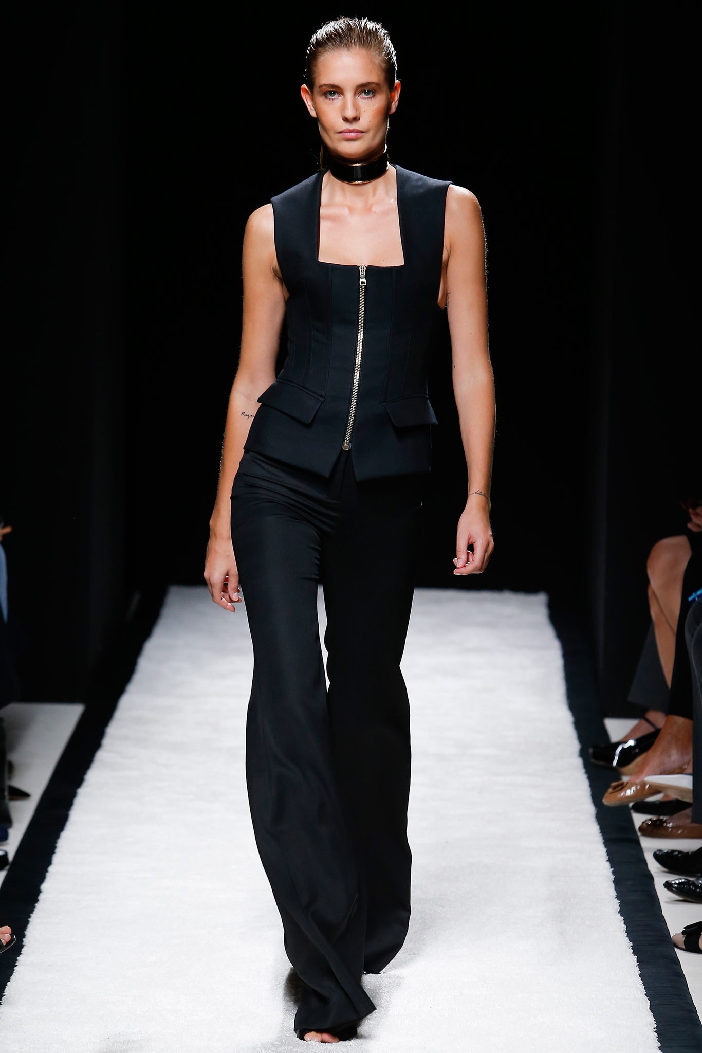 black fitted sleeveless jacket and flared pants