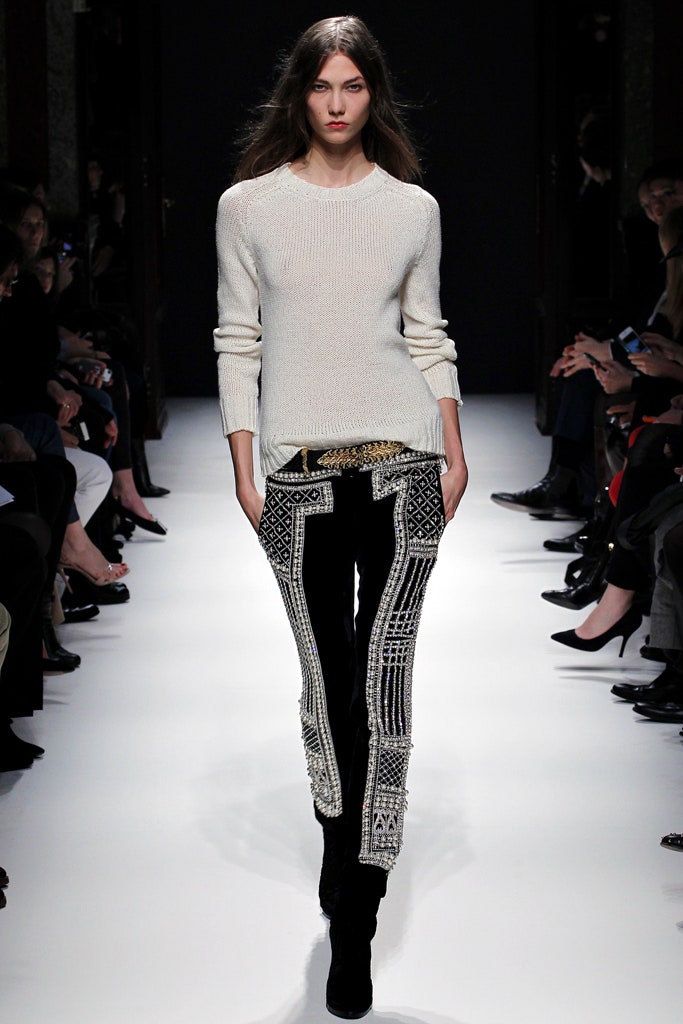 white fitted sweater and black embroidered pants