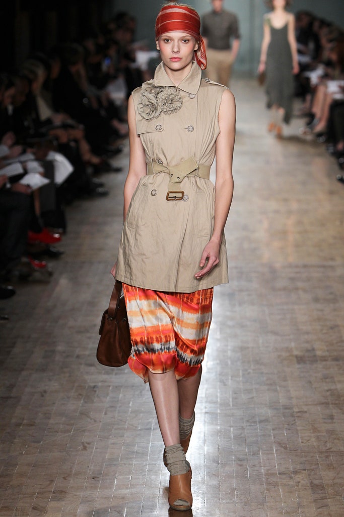 beige trench coat and orange dress