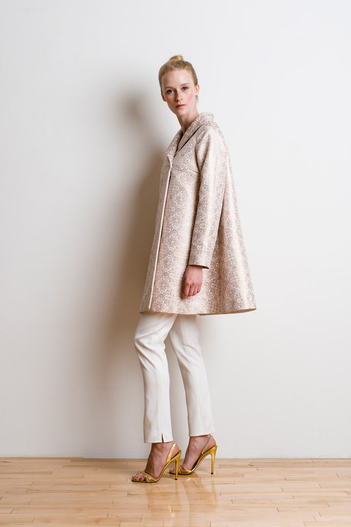 beige embroidered coat with white pants