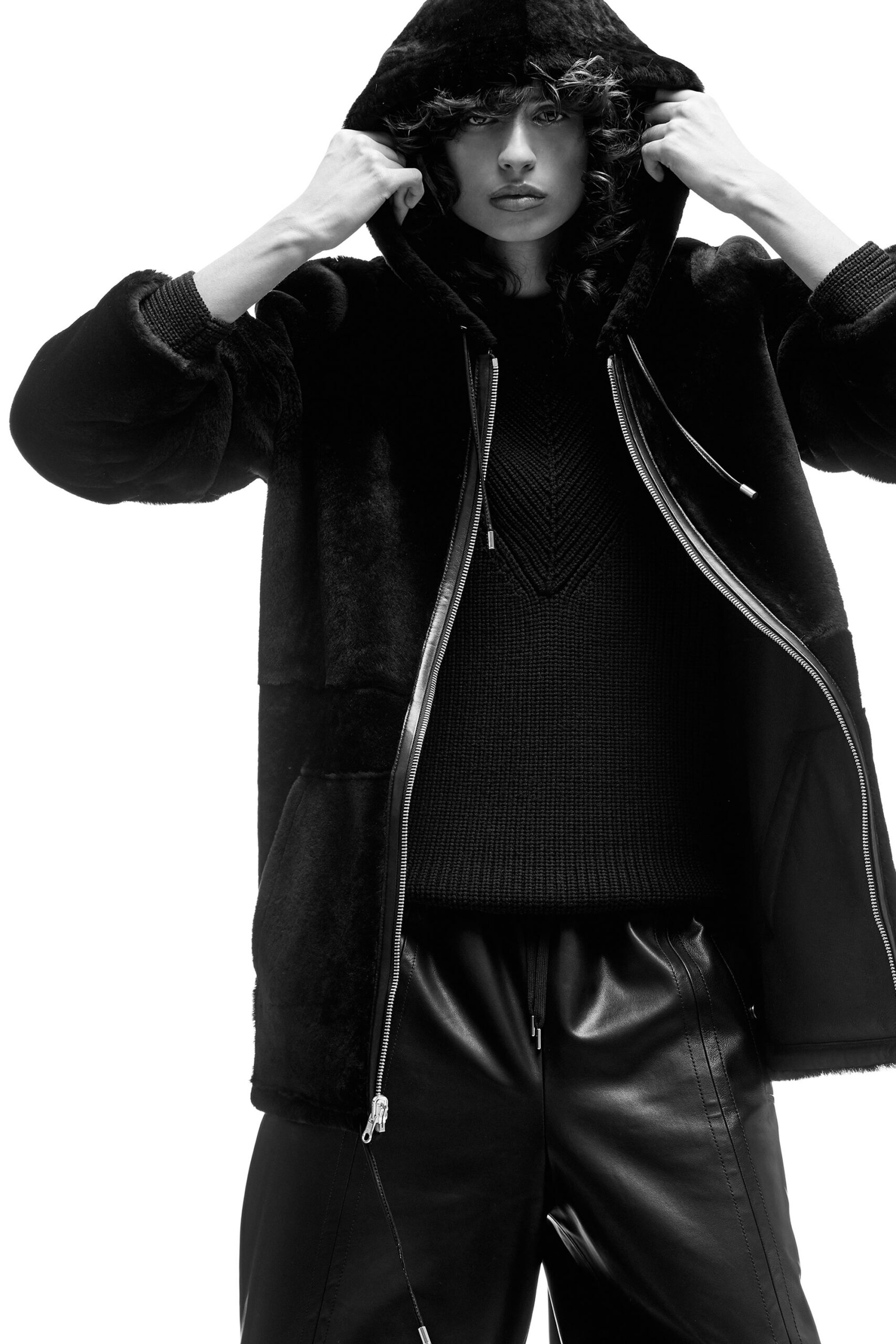 black faux-fur coat with knit sweater