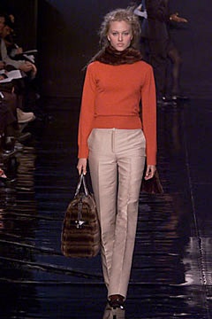 orange fitted sweater beige tailored pants