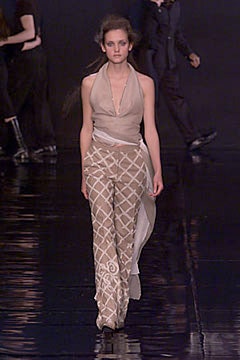 beige silk sleeveless top and embroidered pants