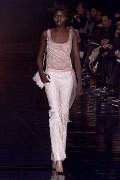 pink silk sleeveless top and white pants
