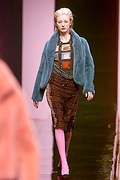 blue faux-fur jacket with gray top and brown skirt