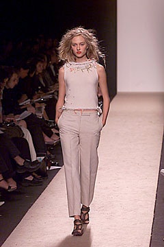 white embroidered sleeveless top with beige pants