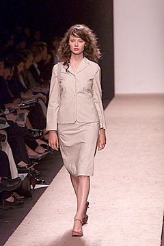 beige fitted suit with red shoes