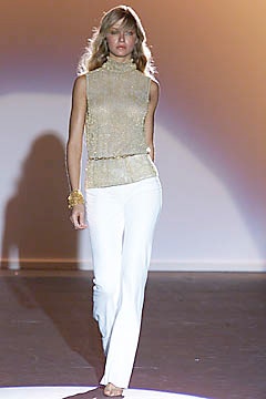 gold beaded sleeveless top with white pants
