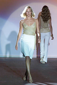 gold silk sleeveless top with white skirt