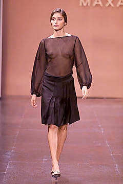 black sheer blouse and pleated skirt