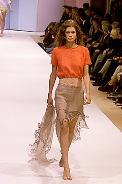 orange cropped top and beige skirt