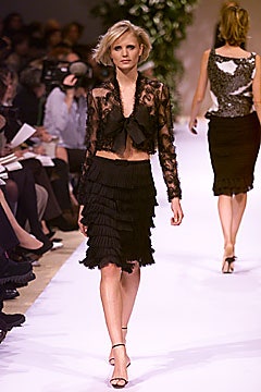 black lace blouse and pleated skirt