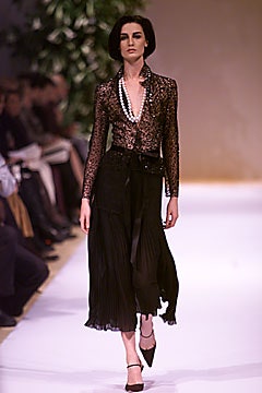 black lace blouse and pleated skirt