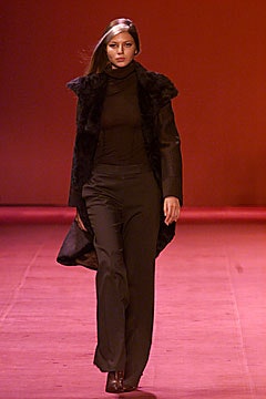 black faux-fur coat with fitted top and flared pants