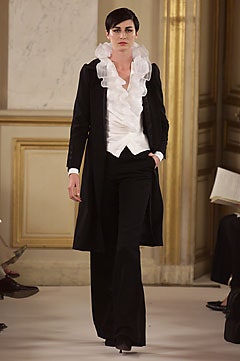 black coat white ruffled blouse