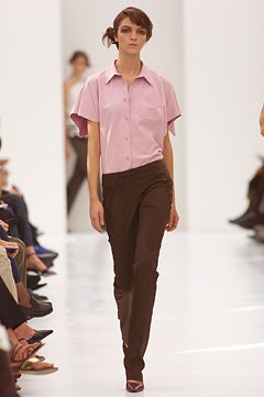 pink collared shirt and brown pants