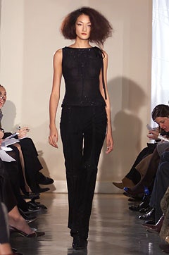 black silk sleeveless top and fitted pants