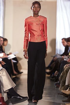 fitted orange silk jacket with black pants