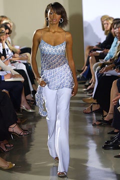 blue sheer sleeveless top with white pants