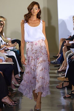 white relaxed top and pink embroidered skirt