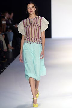 beige pleated top with blue skirt