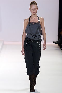 gray silk sleeveless top with black pants