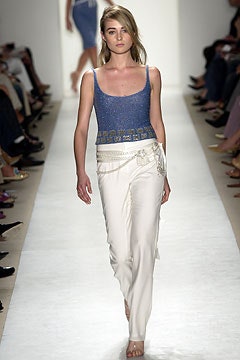 blue silk sleeveless top with white pants