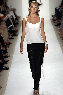 white silk sleeveless top and black pants