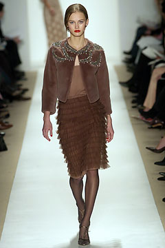 brown fur jacket and pleated skirt