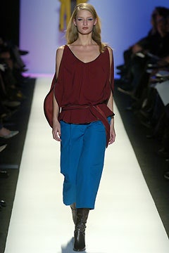 red silk sleeveless top with blue pants
