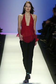 red silk sleeveless top and black pants