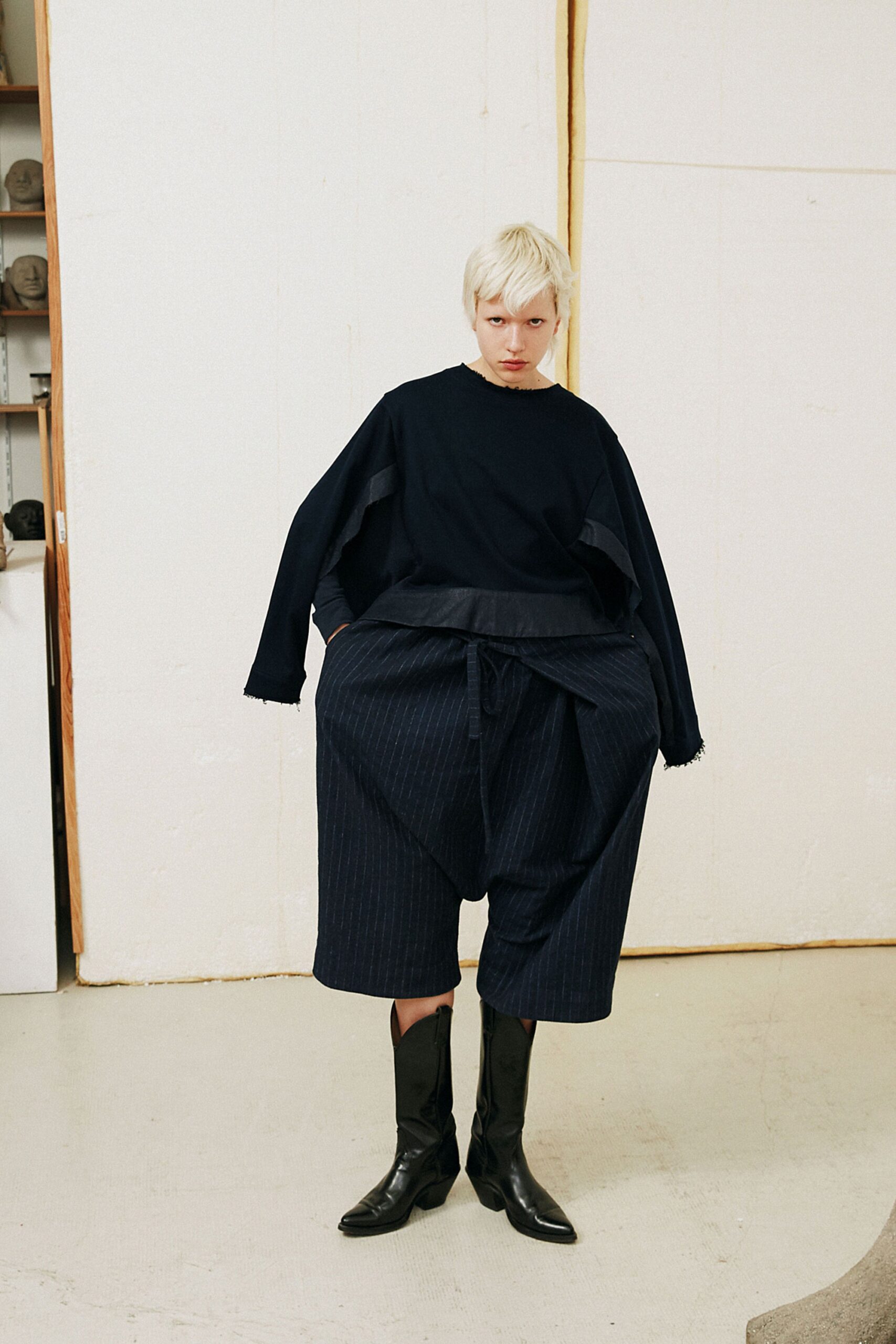 oversized black top with relaxed blue pants