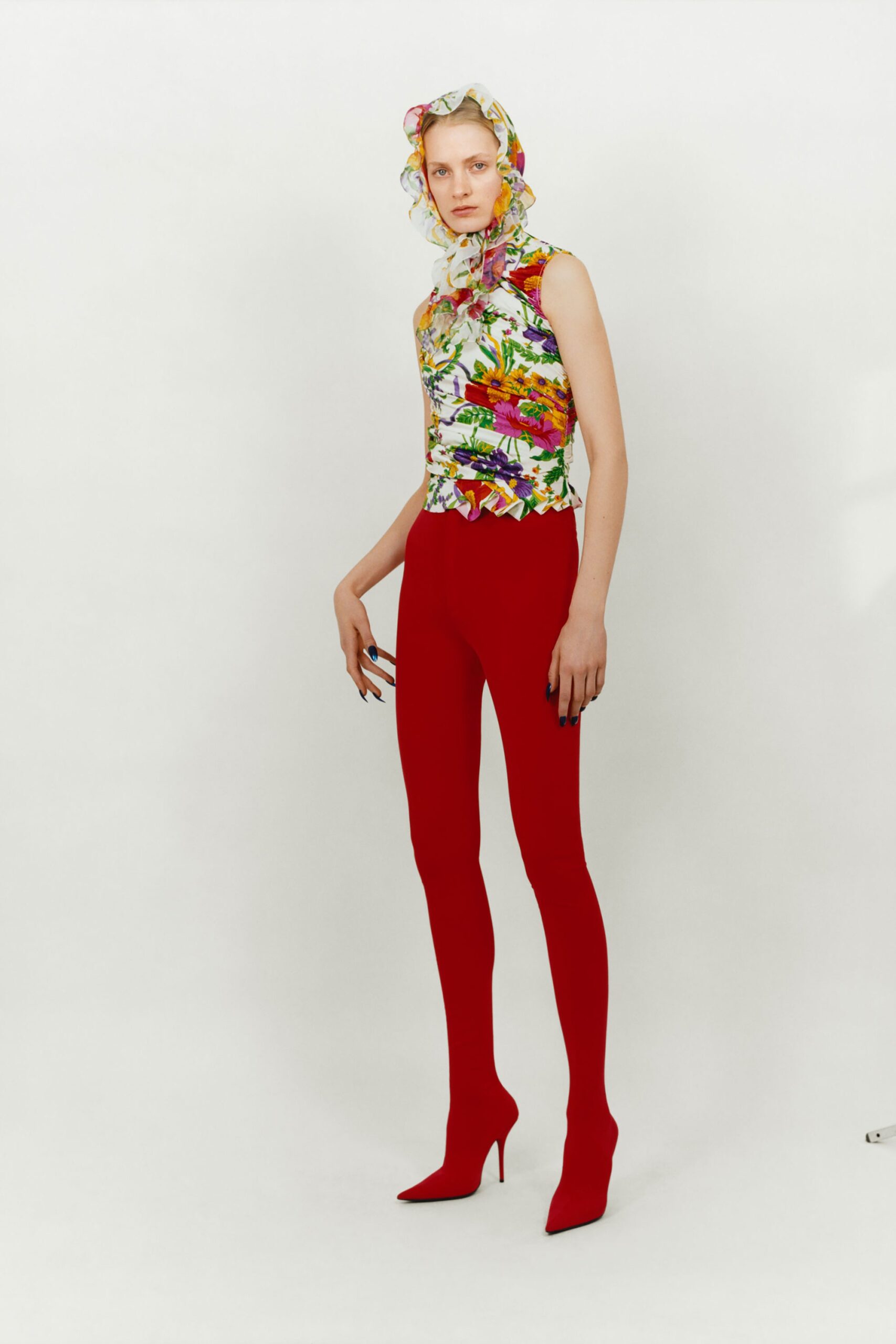 multi-colored ruffled top with red pants