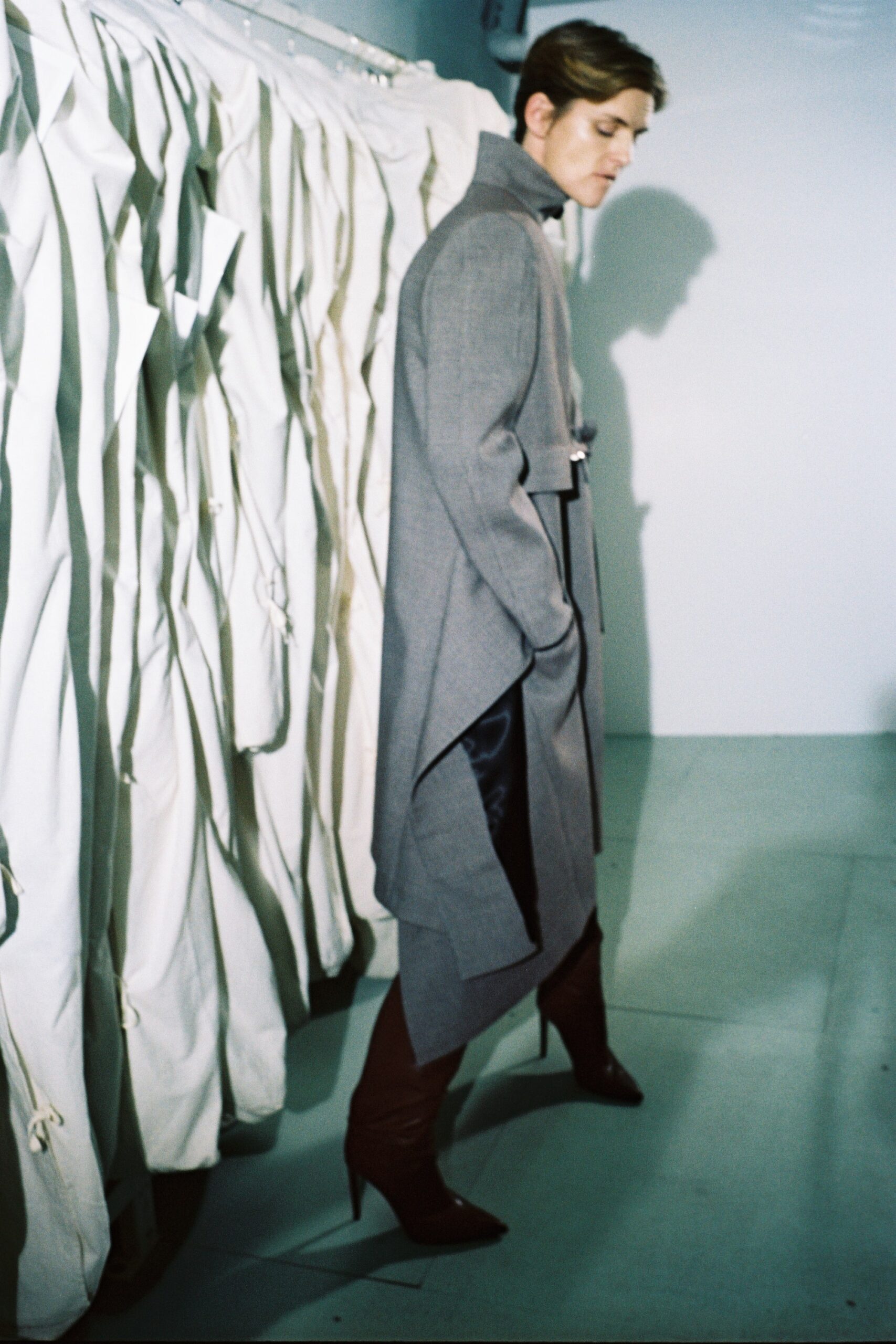 gray wool asymmetric coat with brown boots
