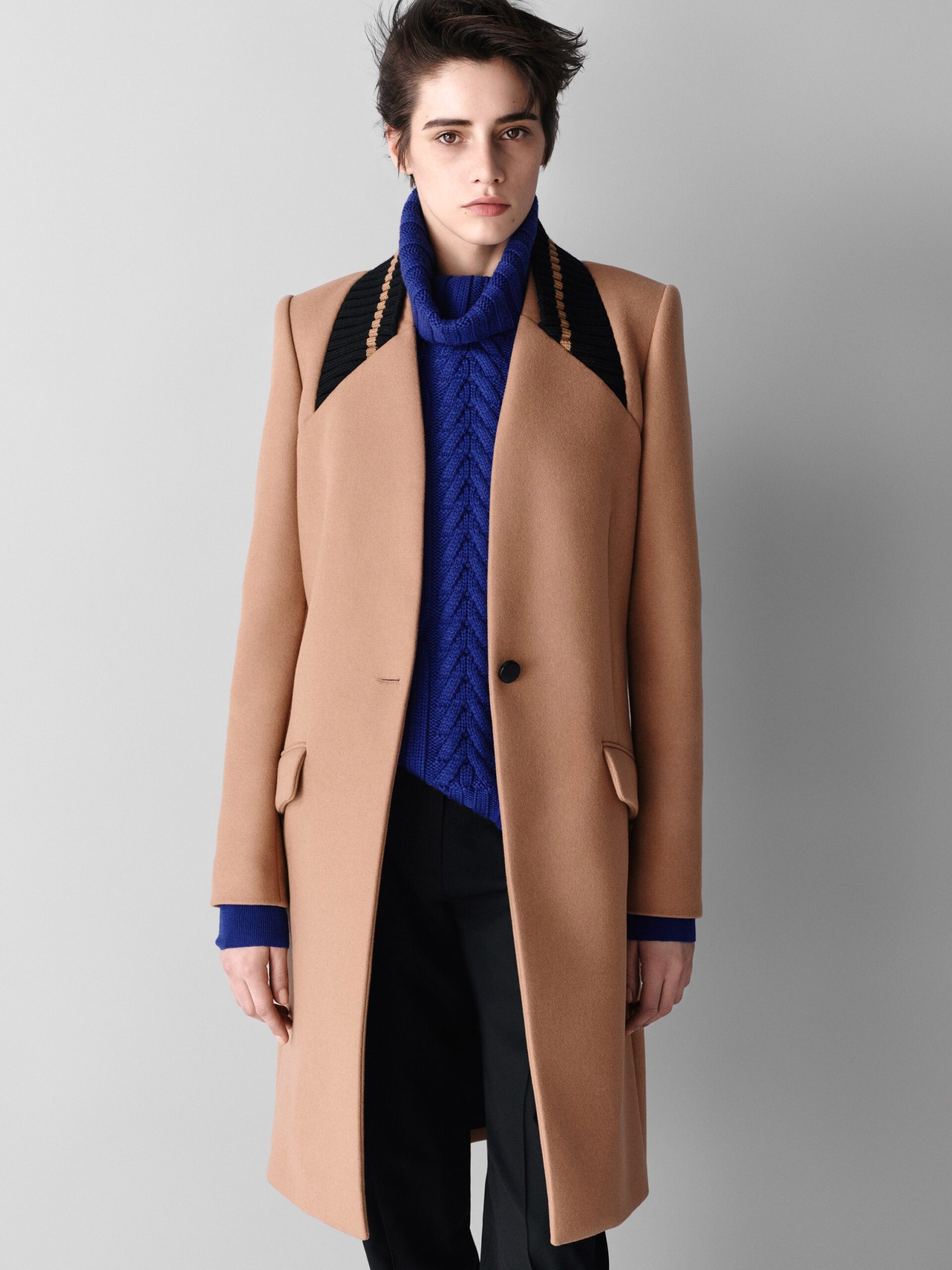 beige wool tailored coat with blue sweater