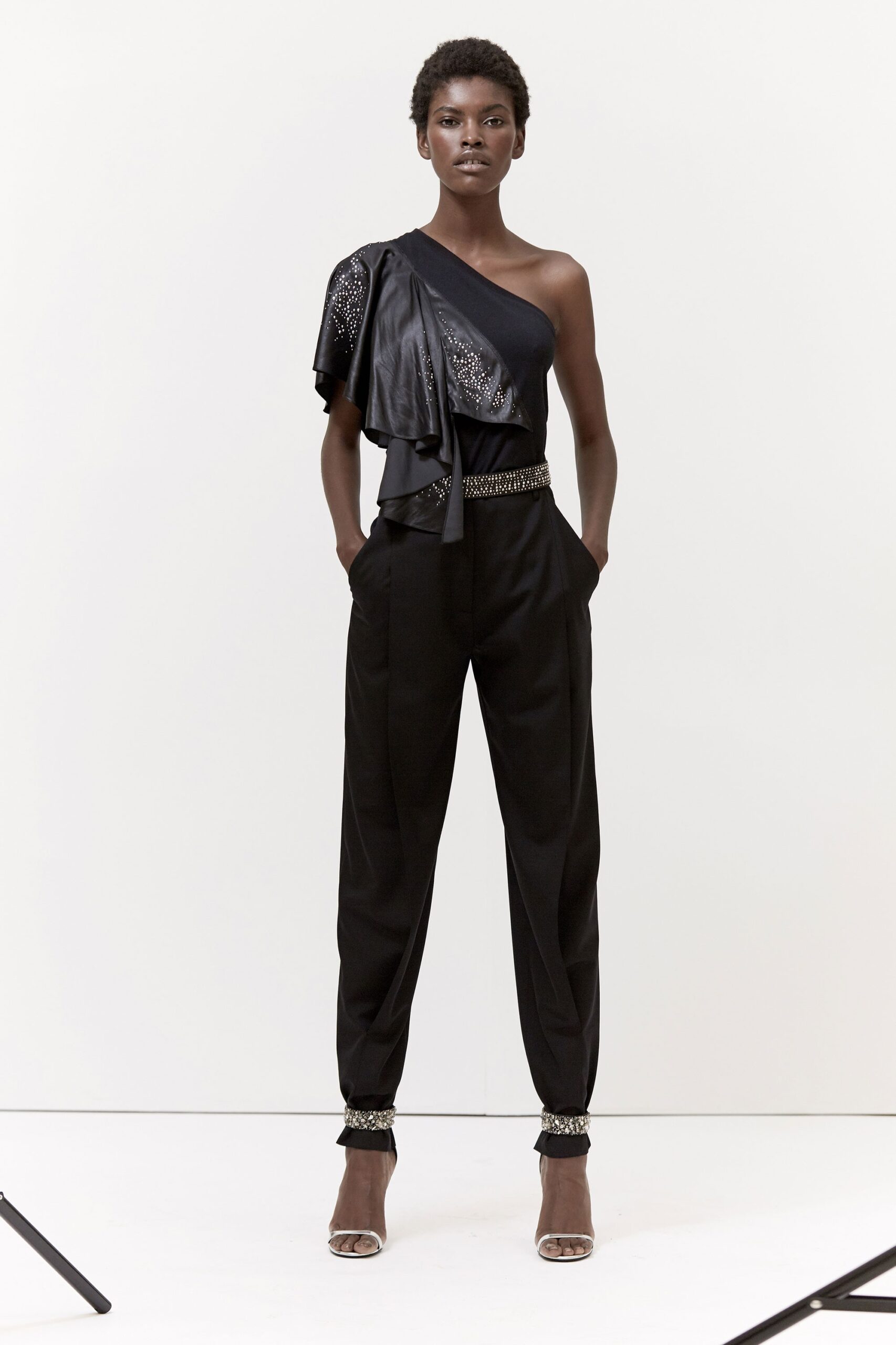 black leather asymmetric top with tailored pants