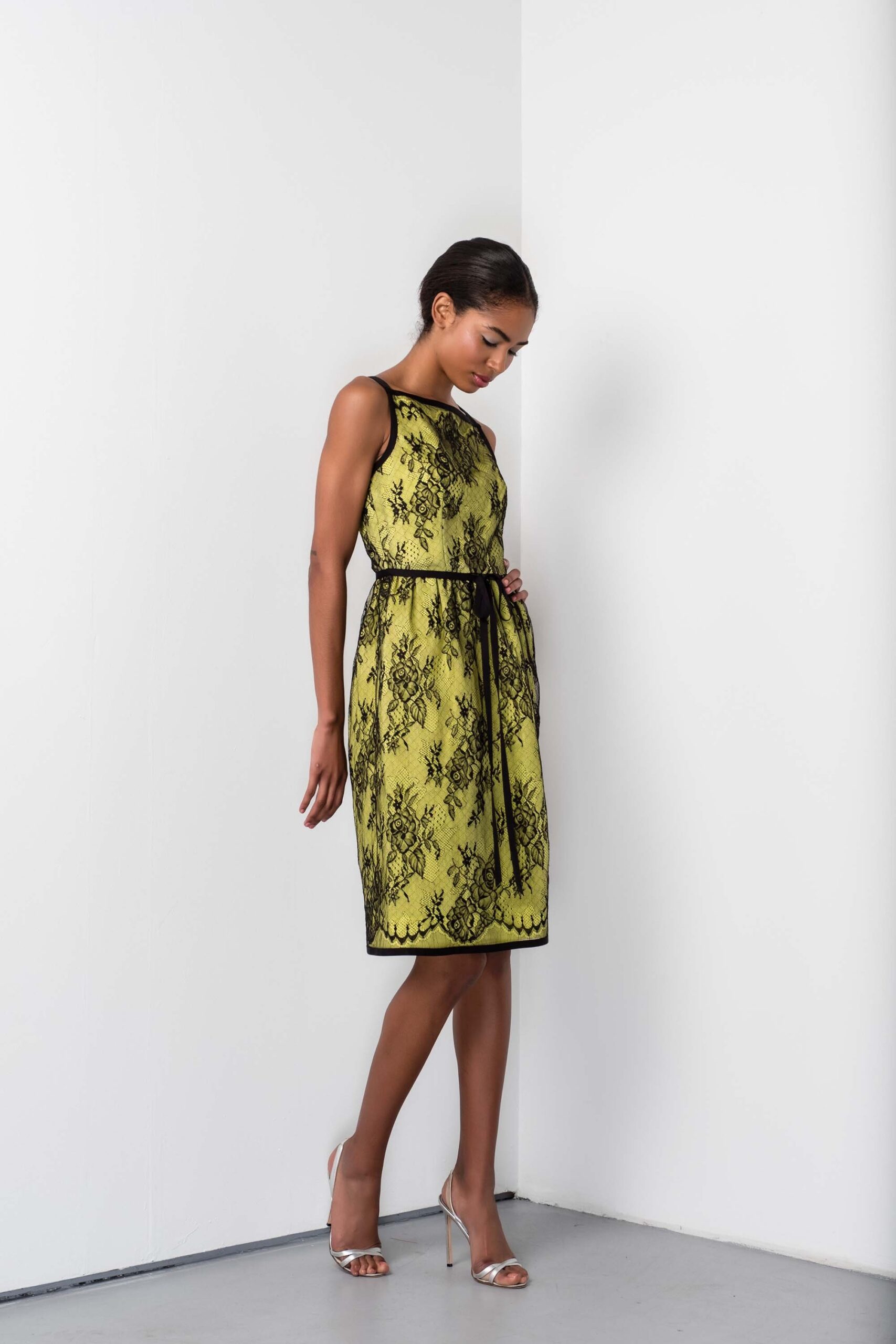 yellow black lace midi dress with silver shoes