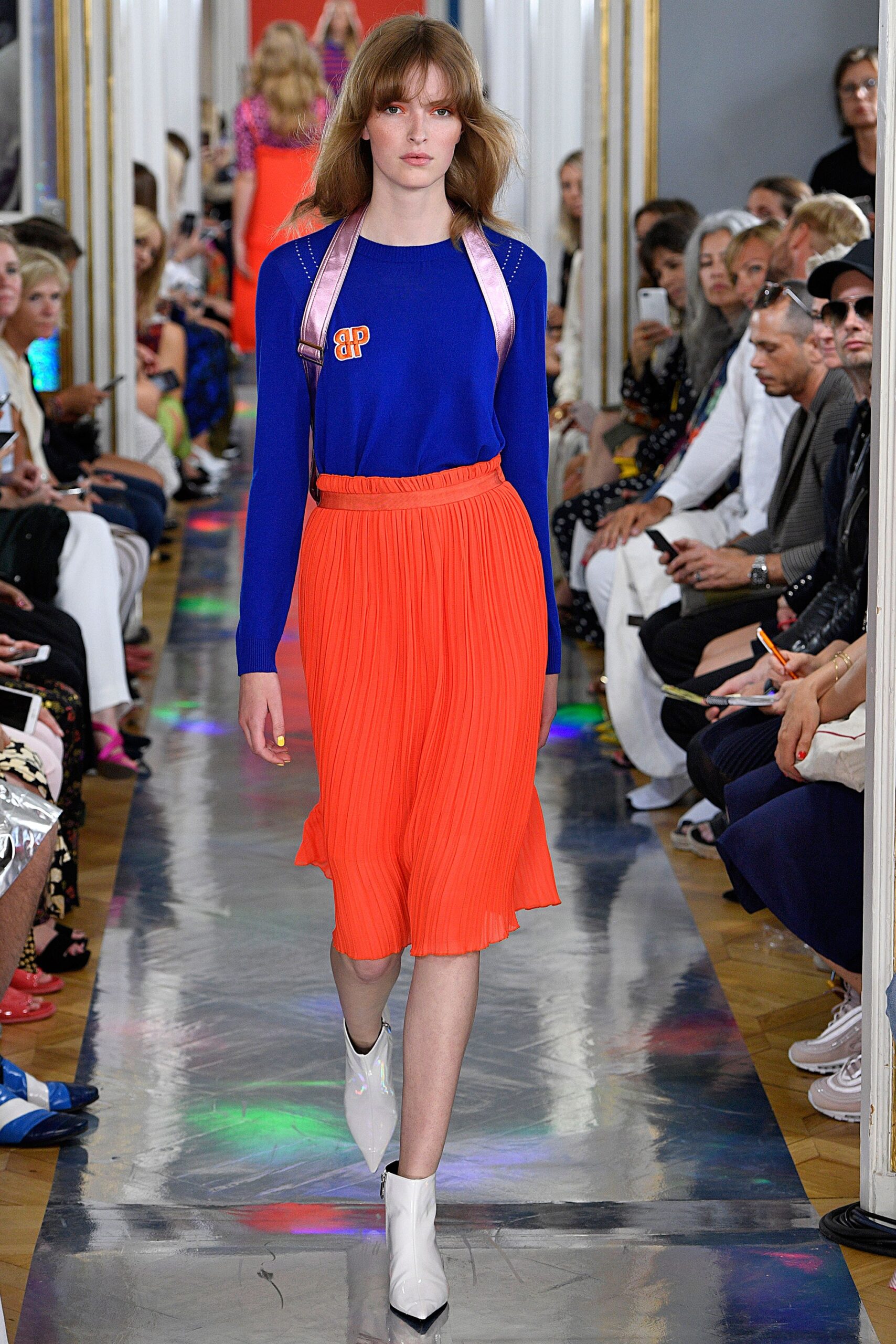 blue fitted top orange pleated skirt