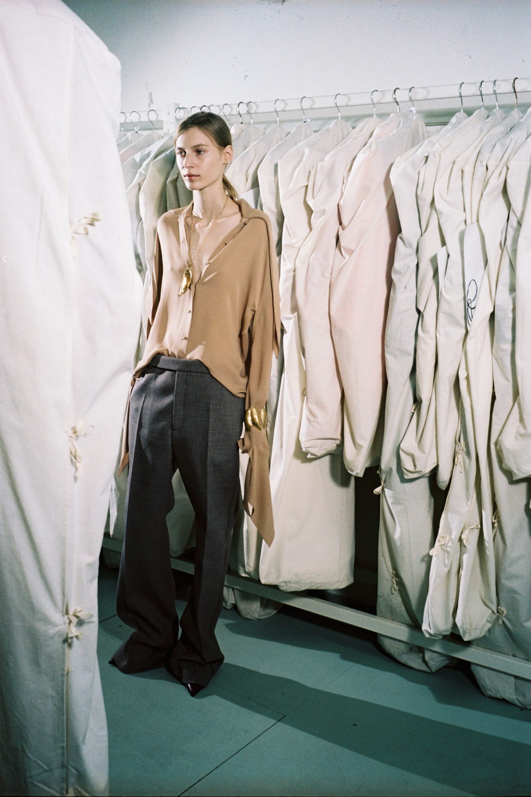 beige silk relaxed shirt and gray tailored pants