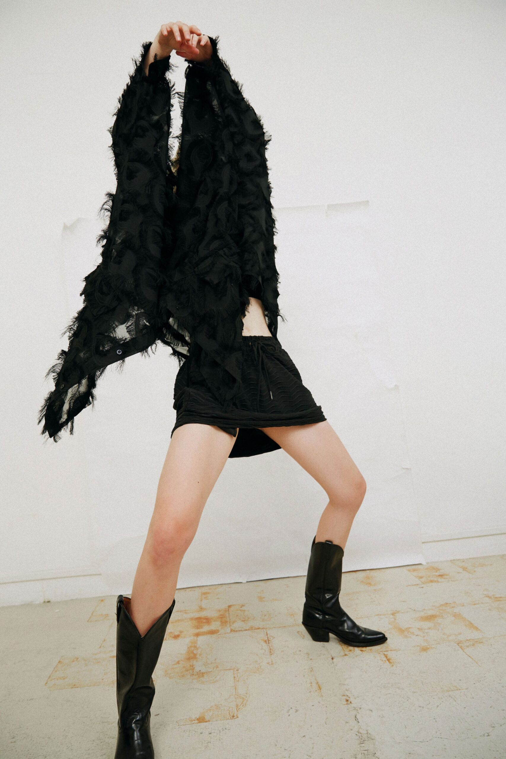 black fringed top with fitted skirt