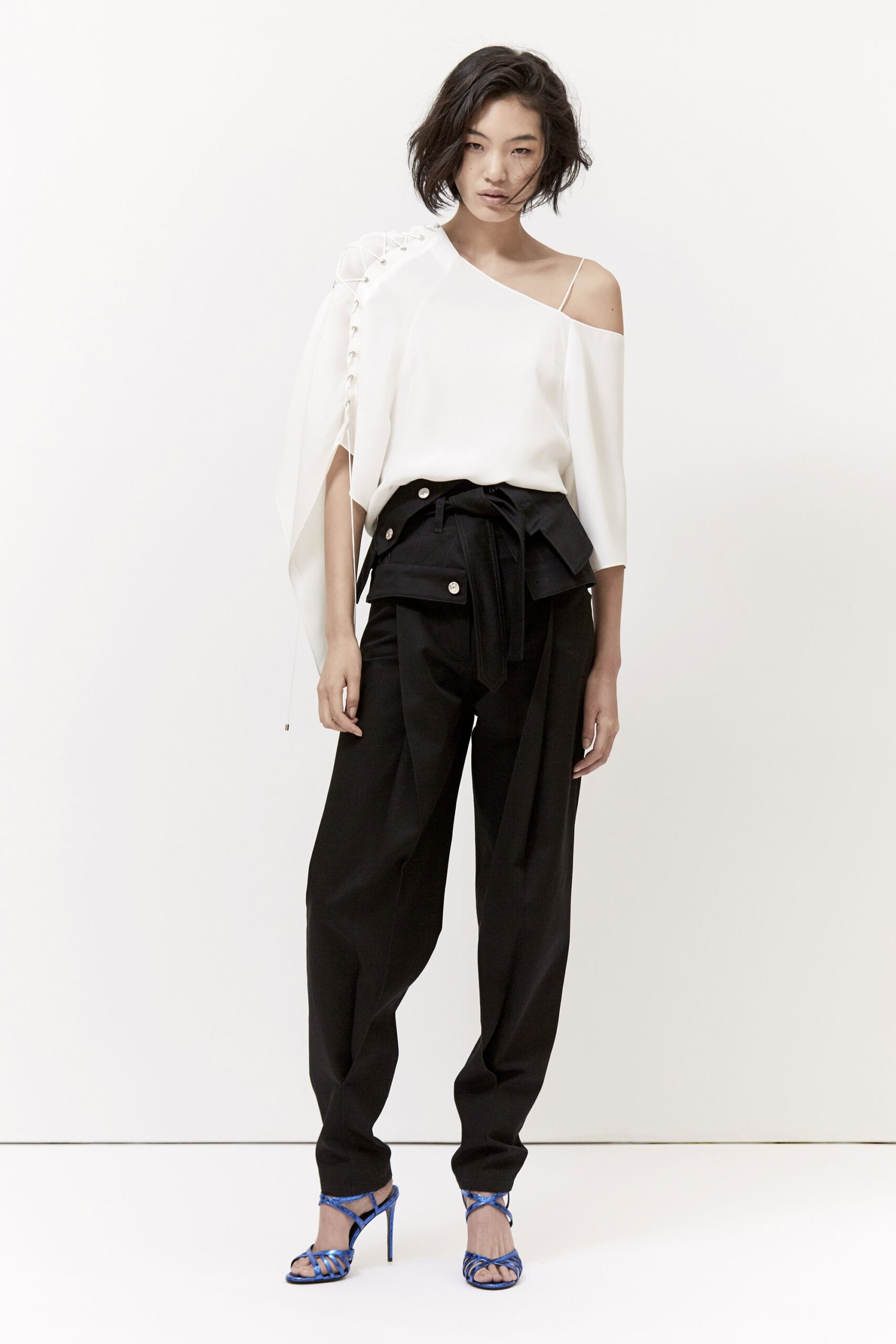 white silk off-shoulder top with black tailored pants