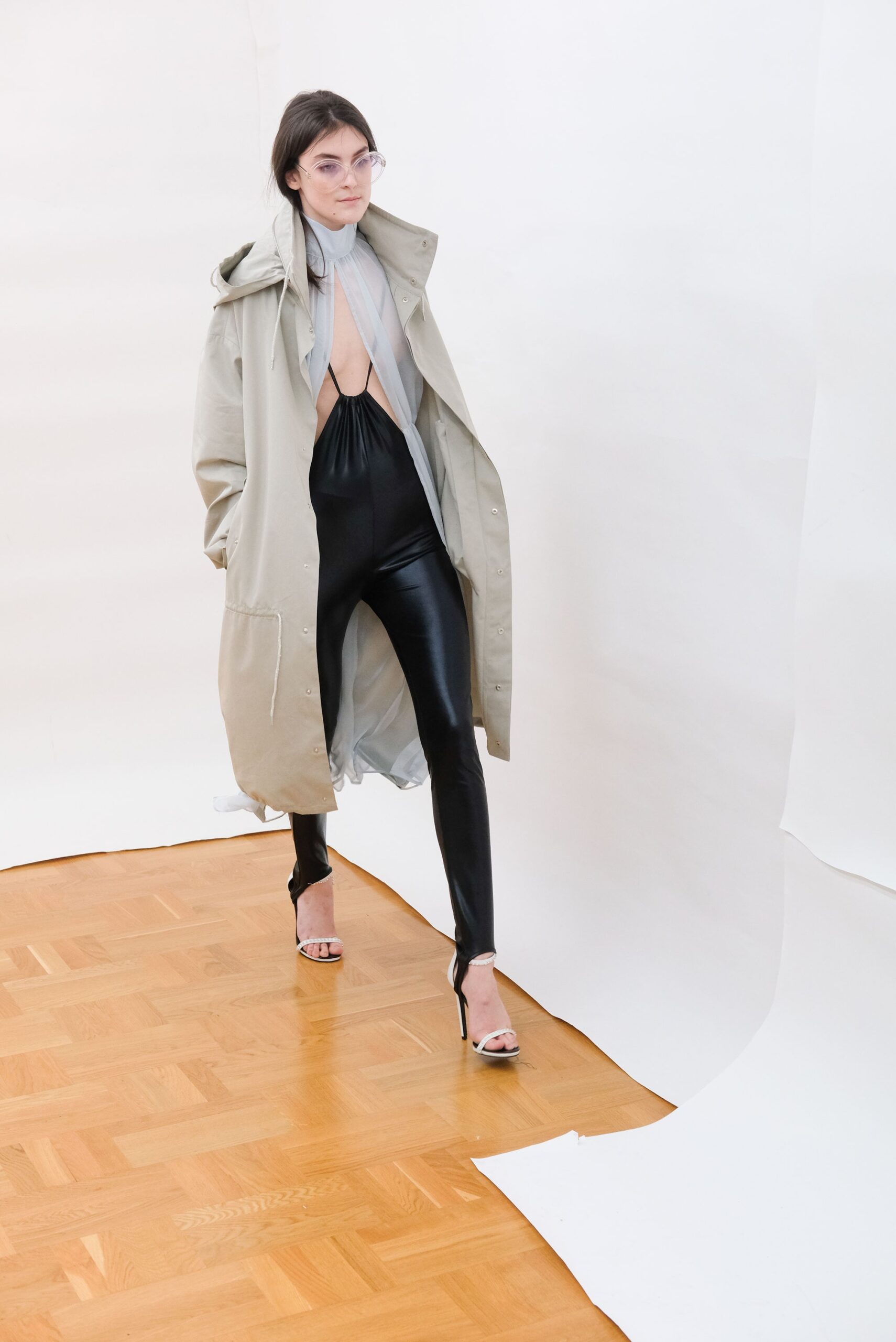 beige oversized coat with black catsuit