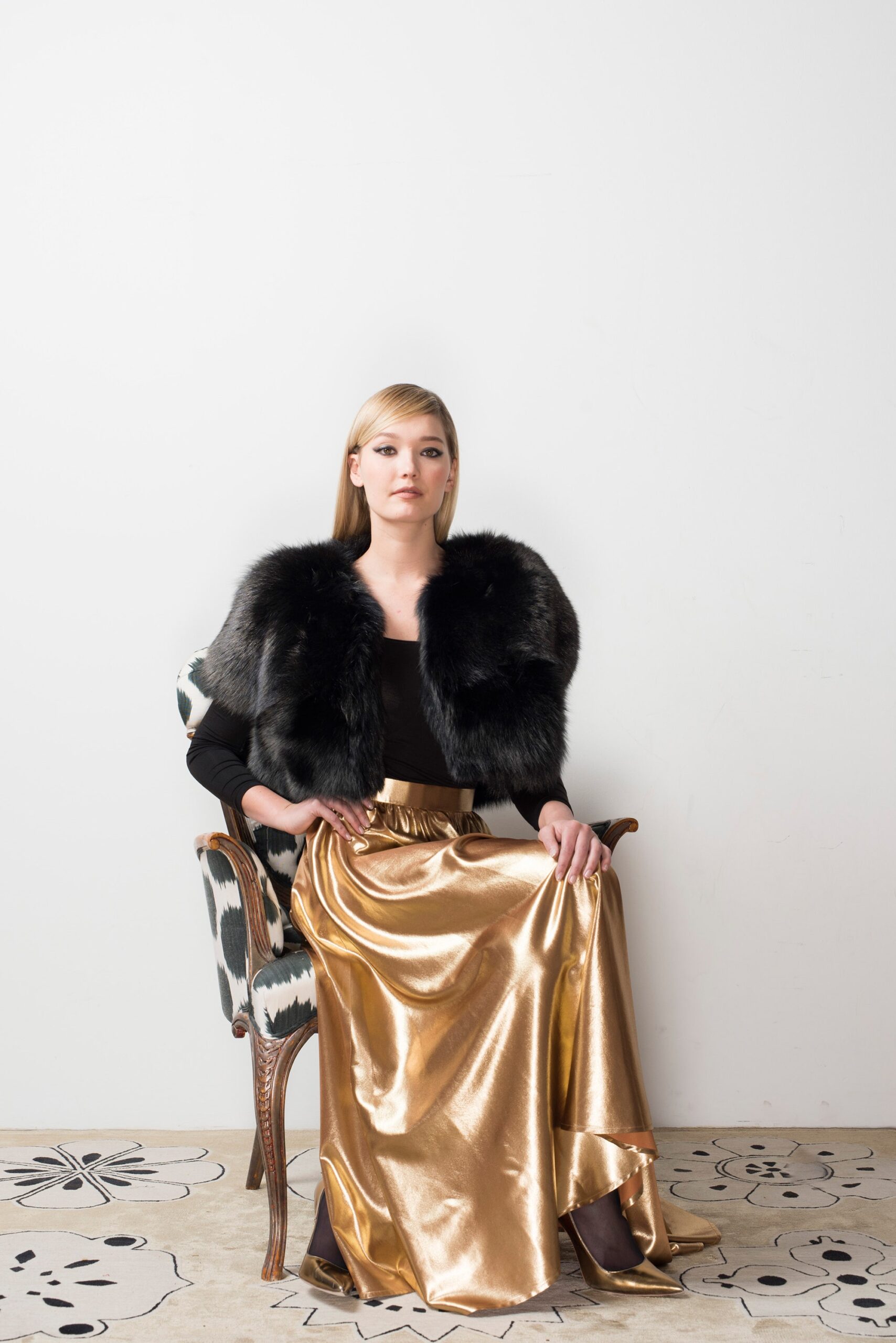 black faux-fur top and gold skirt