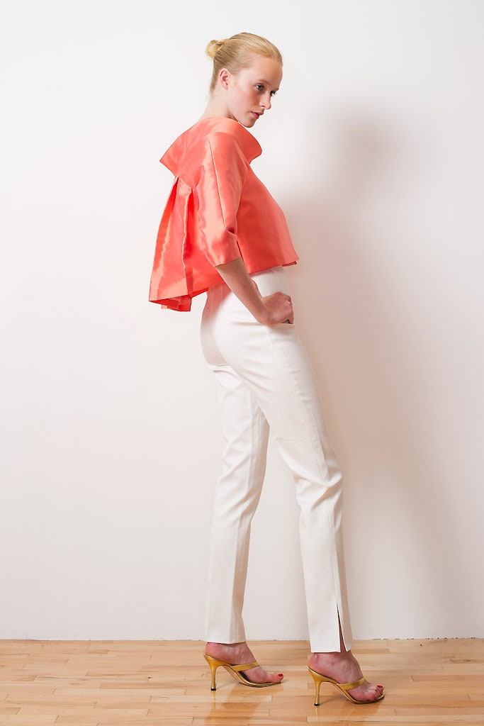 coral silk top with white pants