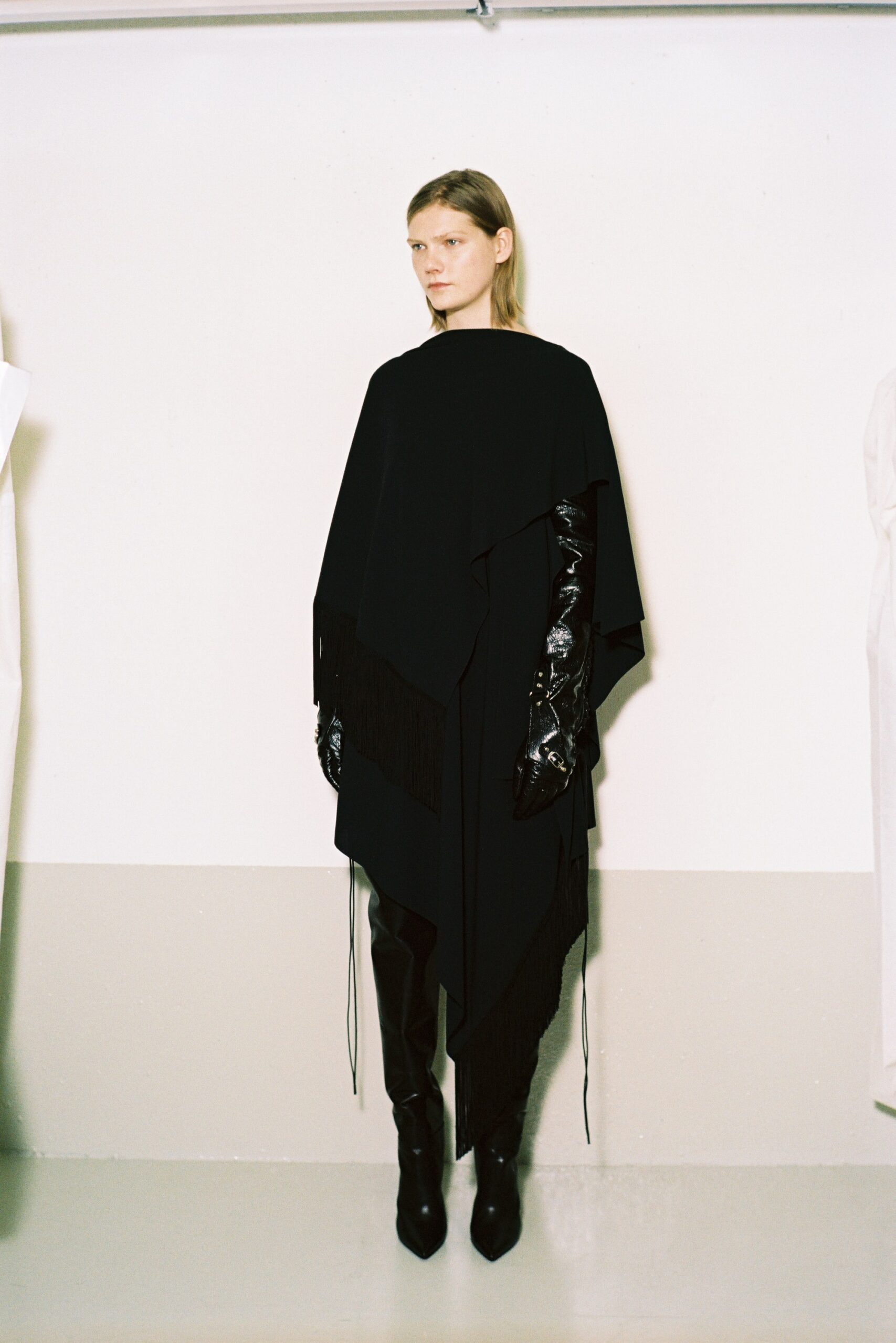 black poncho with leather gloves