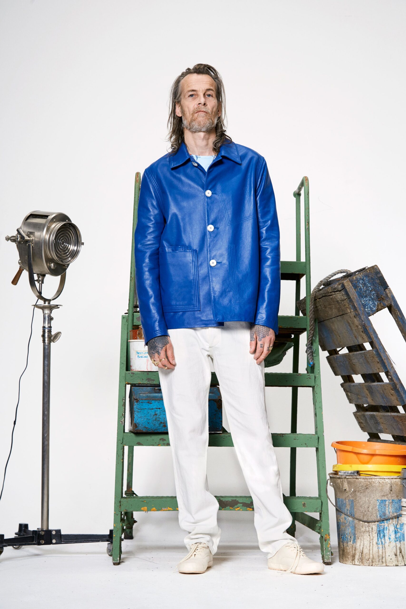 blue leather jacket and white pants
