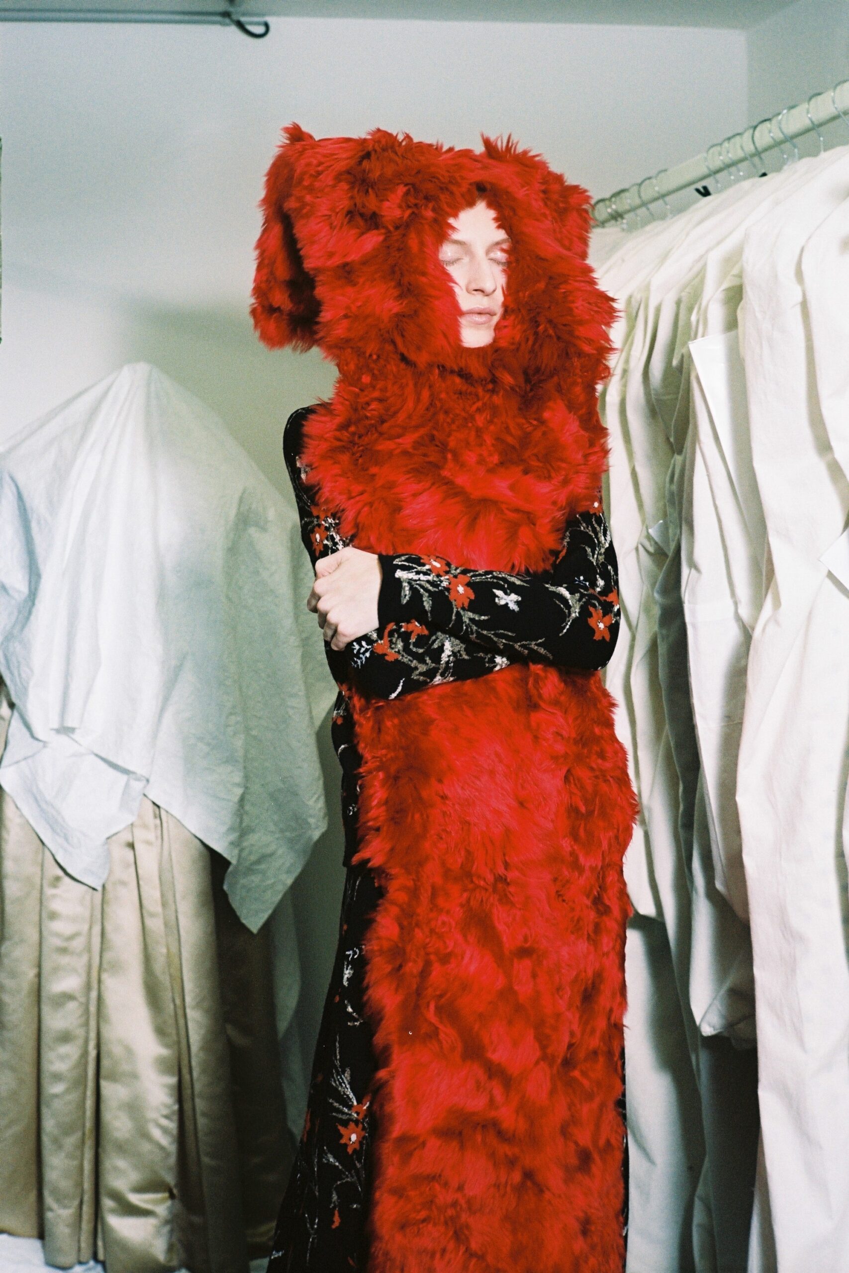black embroidered maxi dress with red fur cape
