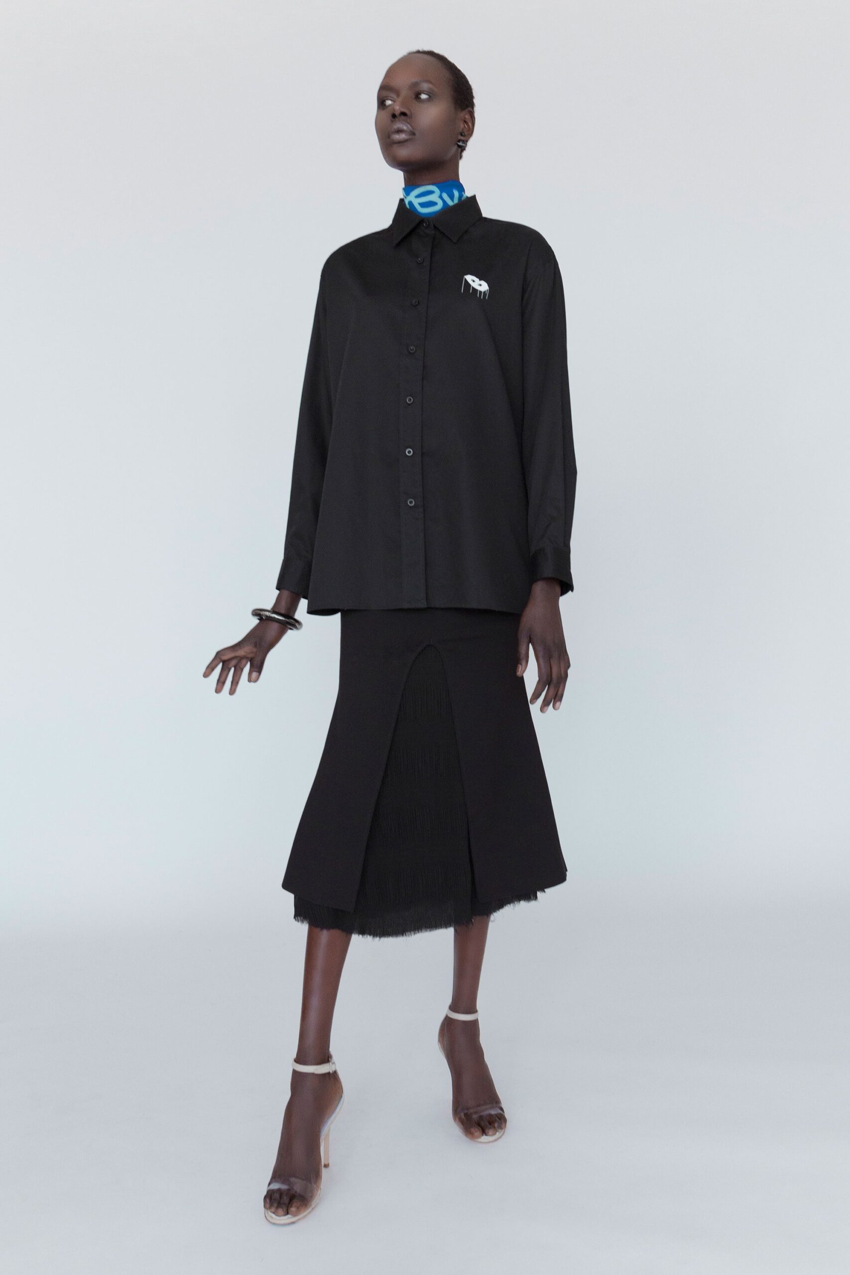 black relaxed shirt and fitted skirt