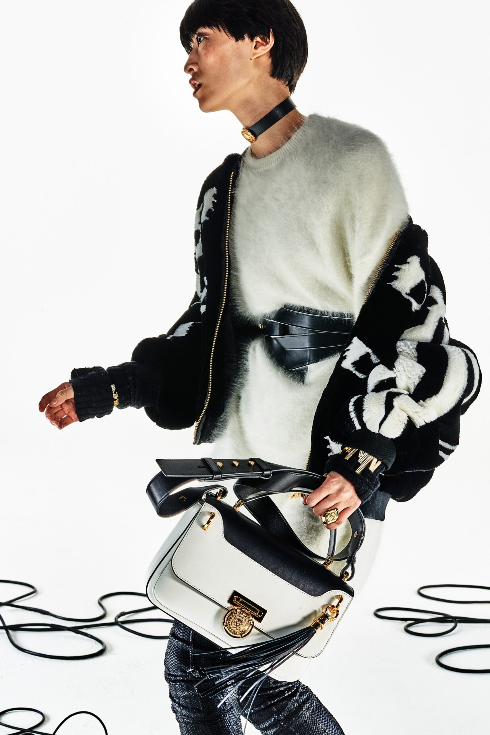 white wool relaxed sweater and black fitted jacket